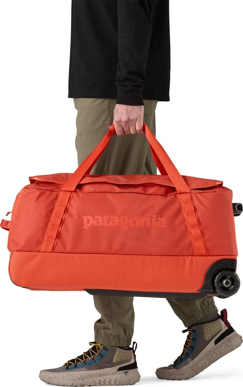 Black Hole Wheeled Duffel 70L - pollinator orange 1